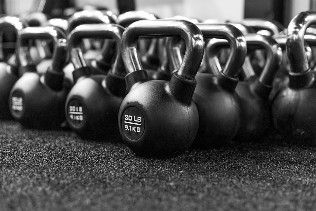 Row of kettlebells lined up on the gym floor