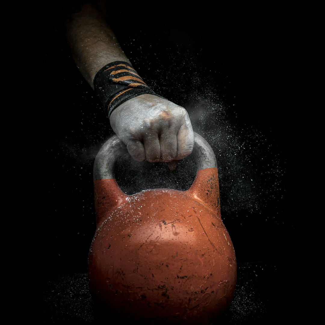 Coach holding a kettlebell in a pressing position